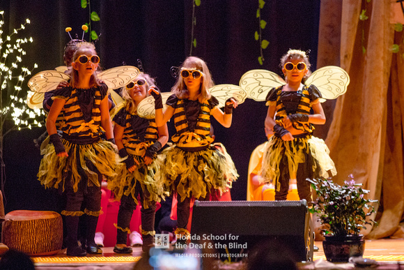 Four bees dance on stage.