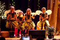 Four bees dance on stage.