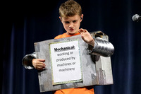 Boy dressed as a robot, word is Mechanical.