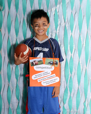 Boy holding football and wearing uniform, word is competition
