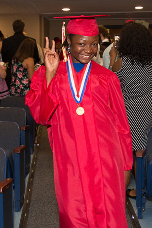 Arlyssa Davis (Deaf) gives the peace sign as she walks down the aisle during the 104th Commencement for the Graduating Classes of 2018