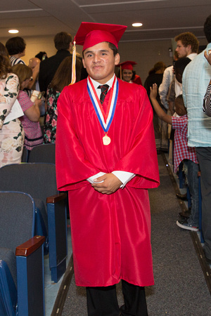 Javier DiGonzalez (Deaf) smiling as he walks down the aisle during the 104th Commencement for the Graduating Classes of 2018