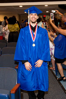 Eric Ortiz (Blind) smiling as he walks down the aisle during the 104th Commencement for the Graduating Classes of 2018